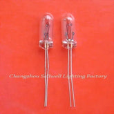 Two miniature 24v 50ma clear glass lamps with wire leads on orange background